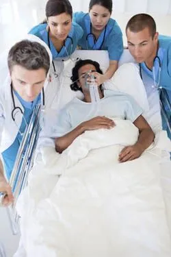 Health Care Providers assisting patient on gurney