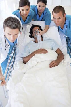 Health Care Providers assisting patient on gurney
