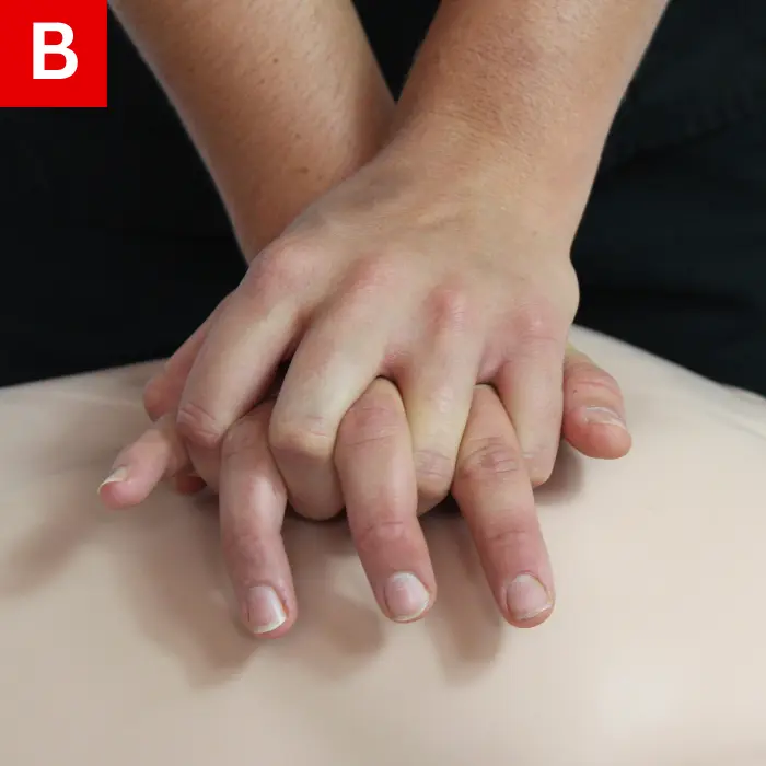 Place the heel of one hand on the lower half of the breastbone