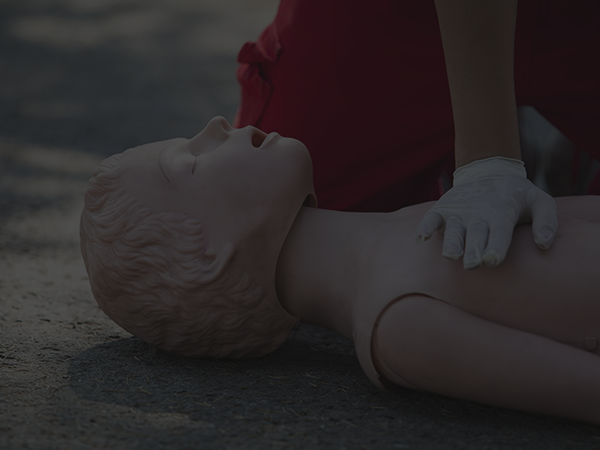 person demonstrating cpr compressions using mannequin