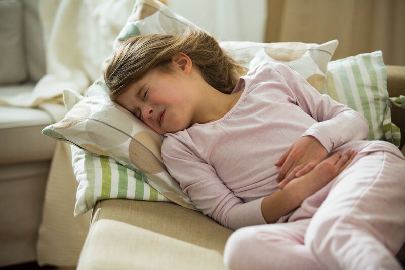 a little girl experiencing stomach pain