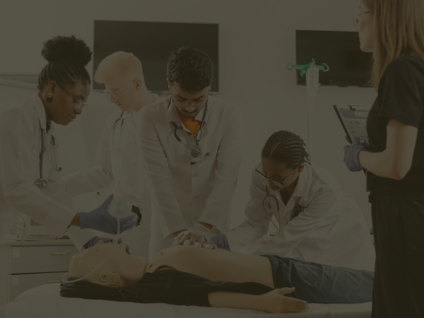 group of medical students performing acls on a mannequin f